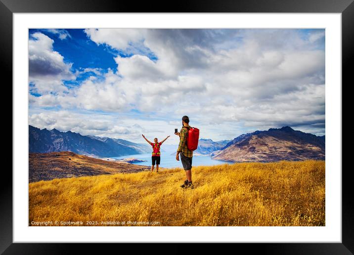 Backpacking young couple taking smartphone picture Lake Wakatipu  Framed Mounted Print by Spotmatik 