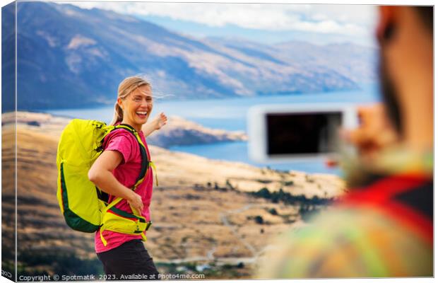 Young male taking picture of happy female Queenstown Canvas Print by Spotmatik 