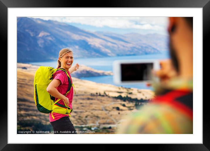 Young male taking picture of happy female Queenstown Framed Mounted Print by Spotmatik 