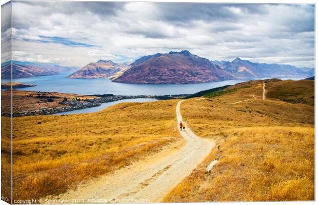 New Zealand Male female hikers trekking The Remarkables Canvas Print by Spotmatik 