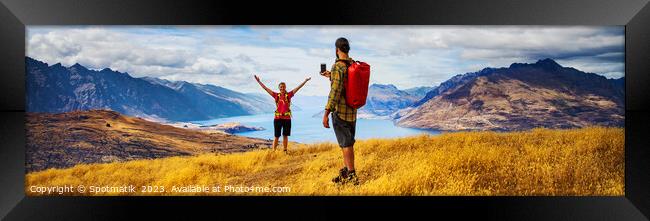 Panorama of young backpacking couple taking smartphone photo  Framed Print by Spotmatik 