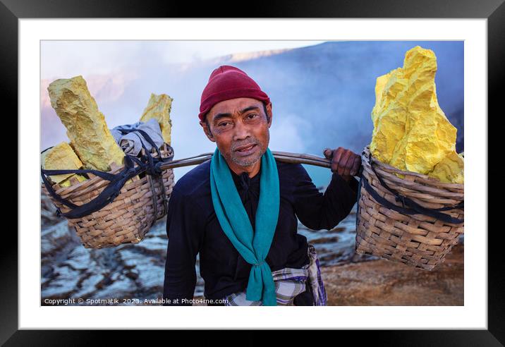 Indonesian worker manually carrying sulphur blocks from volcano  Framed Mounted Print by Spotmatik 