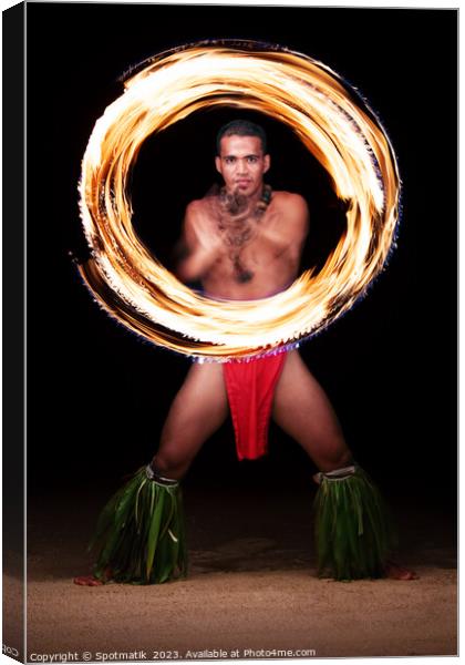 Male Fire dancer illuminated spinning flaming torch Polynesia  Canvas Print by Spotmatik 