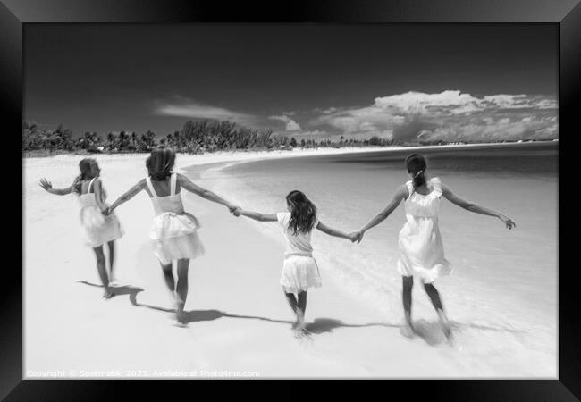 Happy Beach family in white walking holding hands  Framed Print by Spotmatik 