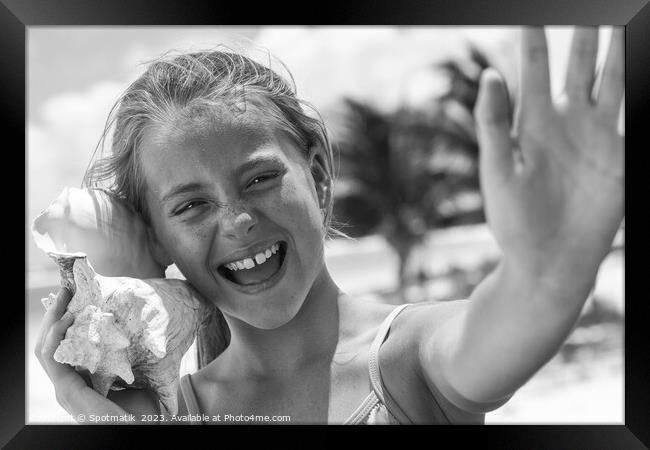 Portrait of beautiful girl with seashell on beach Framed Print by Spotmatik 