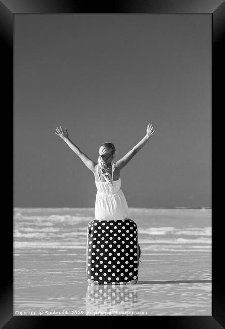 Blonde female teenager on beach sitting on suitcase Framed Print by Spotmatik 