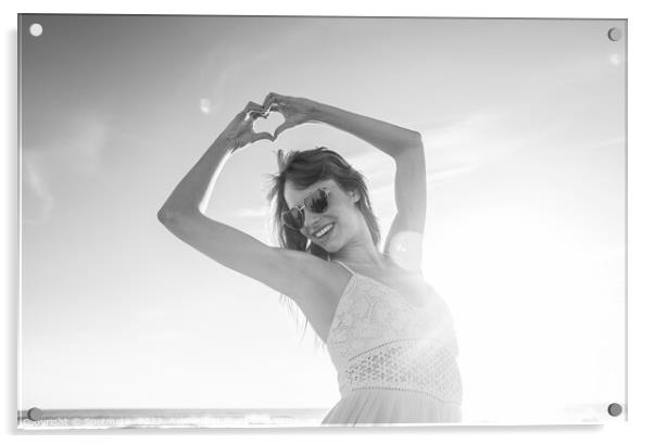 Bohemian girl showing heart sign dancing on beach Acrylic by Spotmatik 