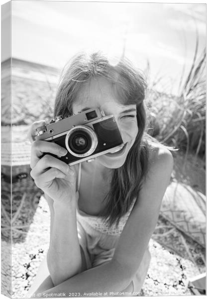 Smiling Caucasian girl with retro camera photograph beach vacation Canvas Print by Spotmatik 