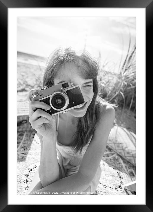 Smiling Caucasian girl with retro camera photograph beach vacation Framed Mounted Print by Spotmatik 