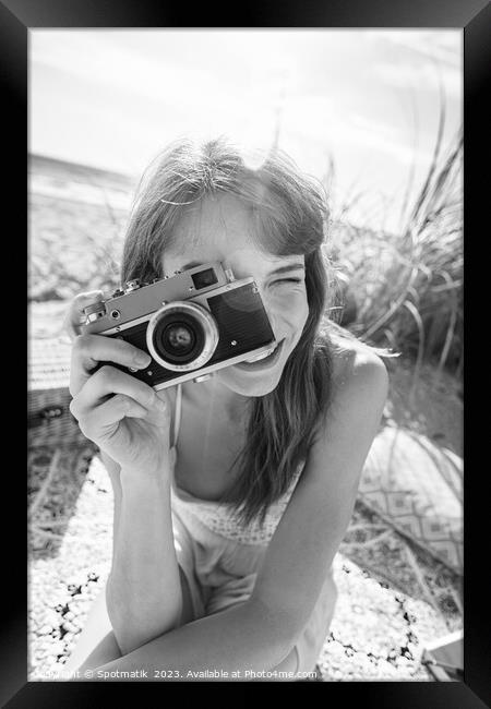 Smiling Caucasian girl with retro camera photograph beach vacation Framed Print by Spotmatik 