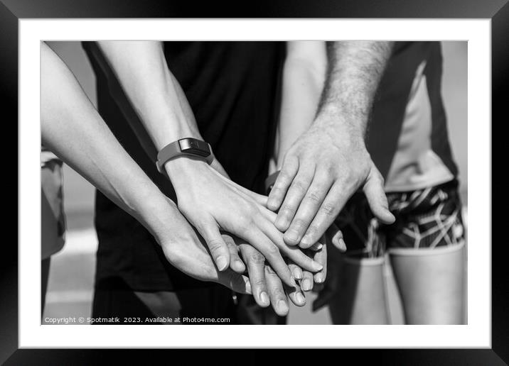 Multi ethnic friends joining hands after beach workout Framed Mounted Print by Spotmatik 
