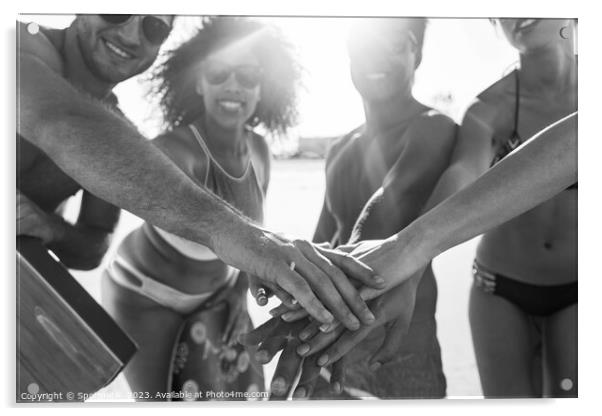 Friends in swimwear joining hands on beach vacation Acrylic by Spotmatik 