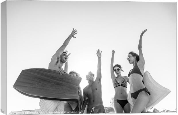 Friends in swimwear with bodyboards celebrating Summer vacation Canvas Print by Spotmatik 