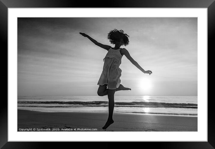 Barefoot young African American woman dancing on beach Framed Mounted Print by Spotmatik 