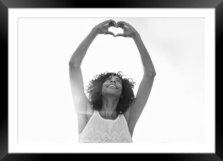 Afro American girl showing heart sign with hands Framed Mounted Print by Spotmatik 