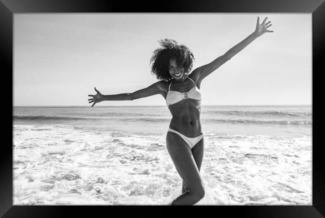 African American girl enjoying Summer fun in ocean Framed Print by Spotmatik 