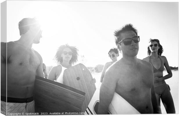 Friends in swimwear carrying bodyboards enjoying Summer vacation Canvas Print by Spotmatik 