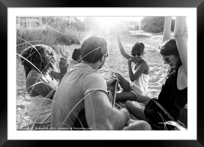 Outdoor fun on beach friends enjoying guitar music Framed Mounted Print by Spotmatik 