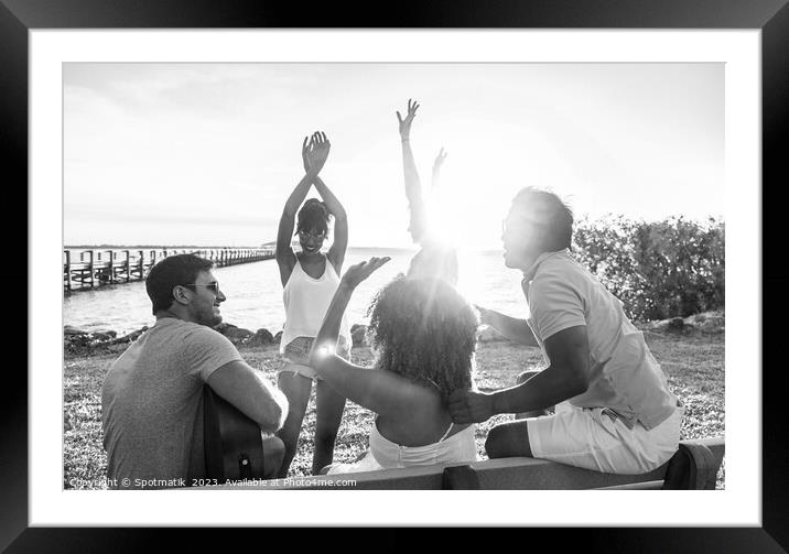 Friends dancing to guitar music outdoors at sunset Framed Mounted Print by Spotmatik 