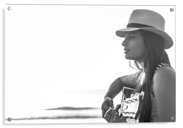Indian woman wearing hat playing guitar on beach Acrylic by Spotmatik 