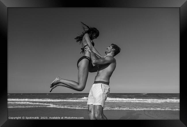 Male and female in swimwear enjoying Summer fun Framed Print by Spotmatik 