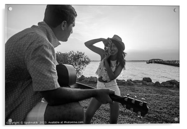 Smiling female taking photograph of partner playing guitar Acrylic by Spotmatik 