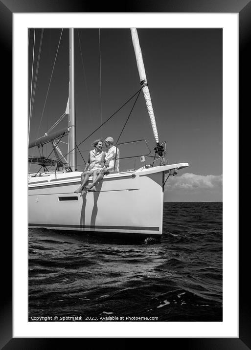 Loving retired couple relaxing together on luxury yacht Framed Mounted Print by Spotmatik 