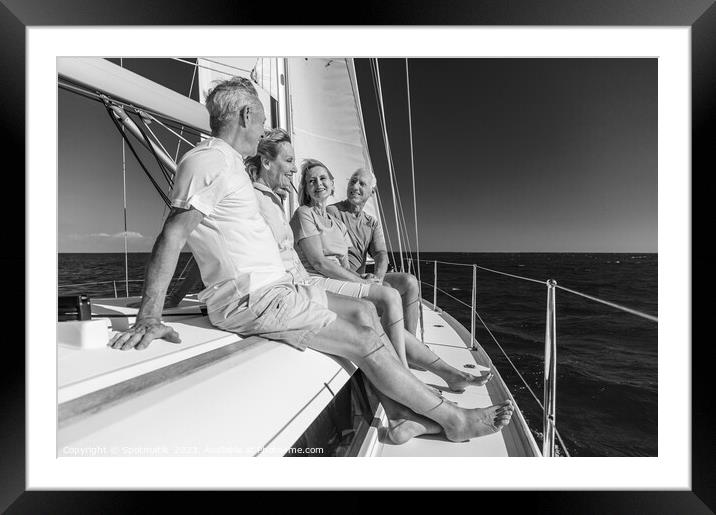 Group of seniors enjoying healthy retirement on yacht Framed Mounted Print by Spotmatik 