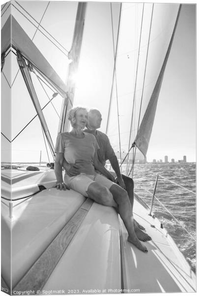 Senior couple enjoying togetherness on yacht at sunset Canvas Print by Spotmatik 