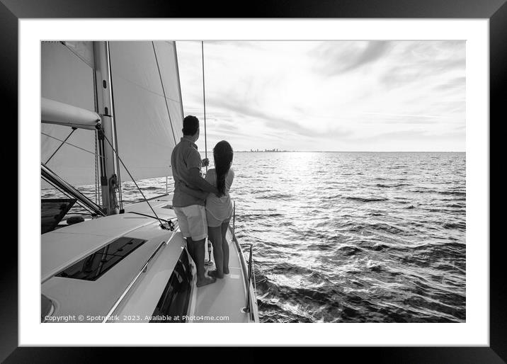 Hispanic couple travelling on luxury yacht at sunset Framed Mounted Print by Spotmatik 