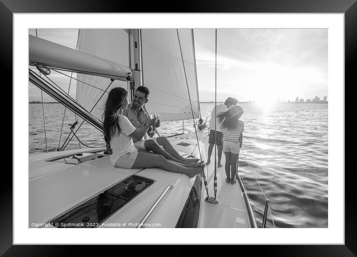 Young family having fun on yacht at sunset Framed Mounted Print by Spotmatik 