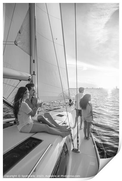 Hispanic family enjoying vacation on yacht at sunset Print by Spotmatik 
