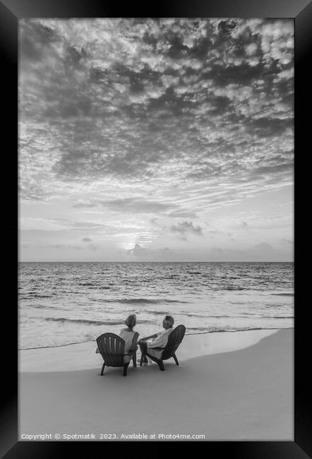 Retired Caucasian couple on beach at sunset Bahamas Framed Print by Spotmatik 