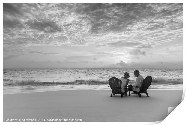 Mature couple enjoying ocean sunset on beach Bahamas Print by Spotmatik 