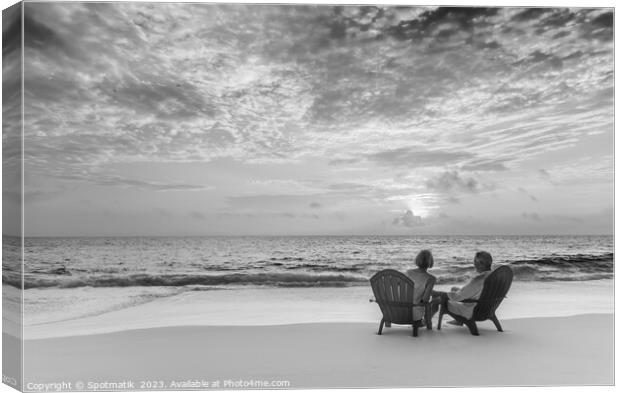 Retired couple enjoying tropical sunrise over ocean Bahamas Canvas Print by Spotmatik 