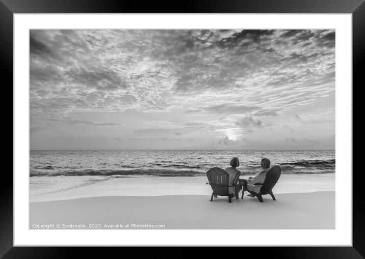 Retired couple enjoying tropical sunrise over ocean Bahamas Framed Mounted Print by Spotmatik 