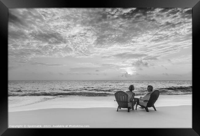 Retired couple enjoying tropical sunrise over ocean Bahamas Framed Print by Spotmatik 