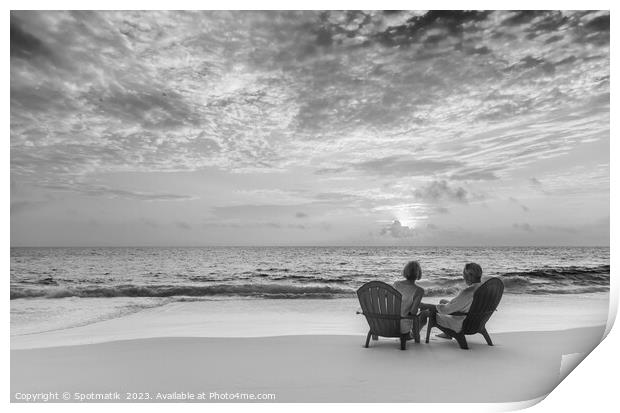 Retired couple enjoying tropical sunrise over ocean Bahamas Print by Spotmatik 