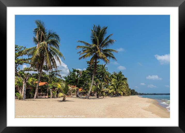 Resort on tropical beach with palm trees in Chumph Framed Mounted Print by Kevin Hellon