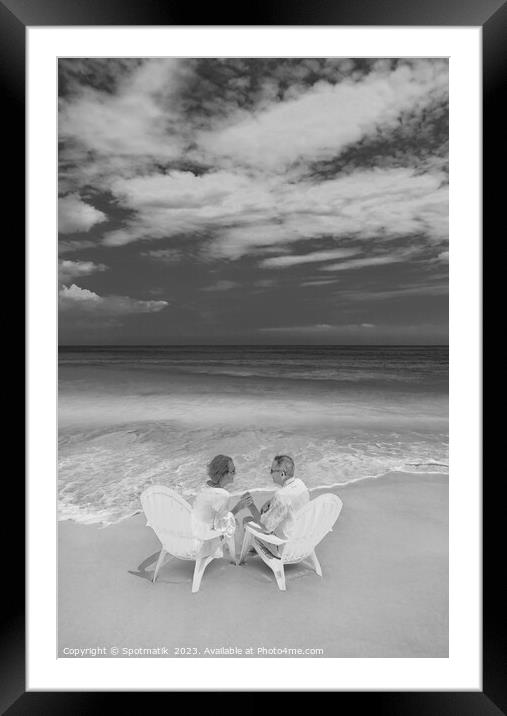 Mature couple on white chairs by ocean Bahamas Framed Mounted Print by Spotmatik 