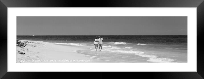Panoramic view retired couple walking by turquoise ocean Framed Mounted Print by Spotmatik 