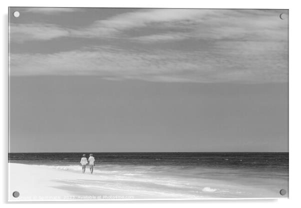 Mature couple walking along shoreline at beach resort Acrylic by Spotmatik 