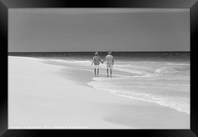 Mature couple paddling on tropical island shoreline Bahamas Framed Print by Spotmatik 