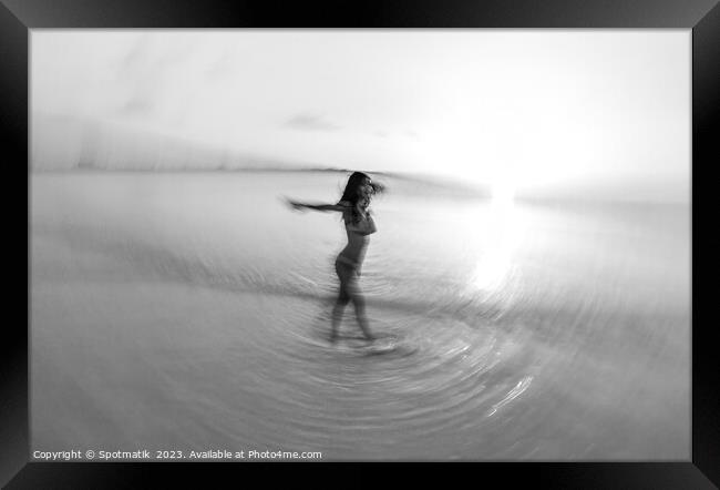 Motion blurred sunset ocean view with dancing female Framed Print by Spotmatik 