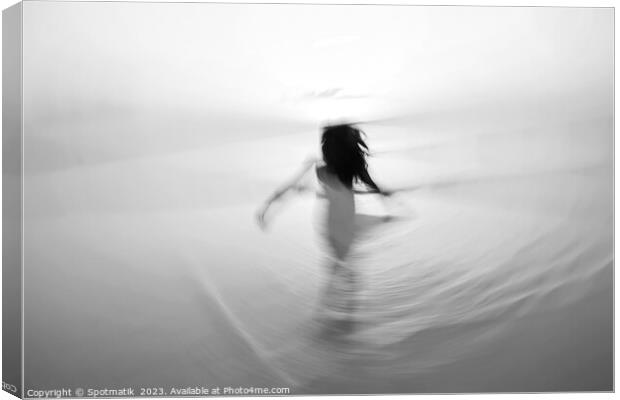 Motion blurred Asian girl dancing in ocean sunrise Canvas Print by Spotmatik 