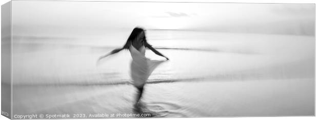 Panoramic motion blurred ocean sunset with dancing girl Canvas Print by Spotmatik 