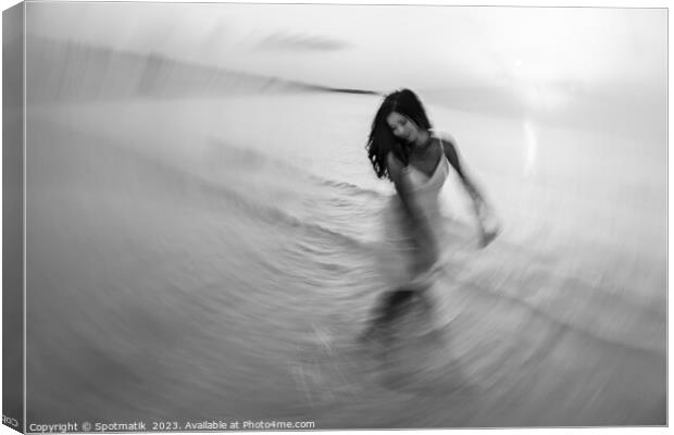 Motion blurred dancing Asian girl in ocean sunset Canvas Print by Spotmatik 