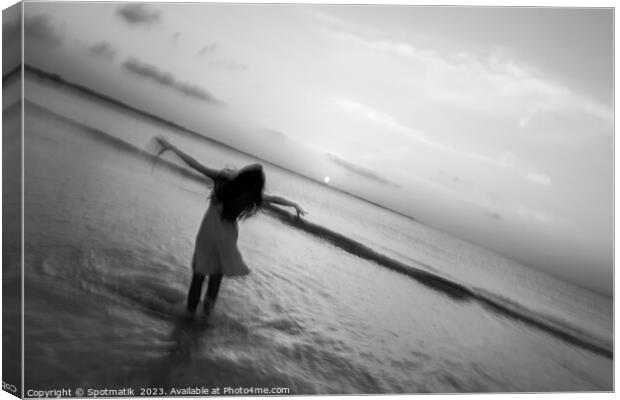 Motion blur girl standing in ocean at sunrise Canvas Print by Spotmatik 