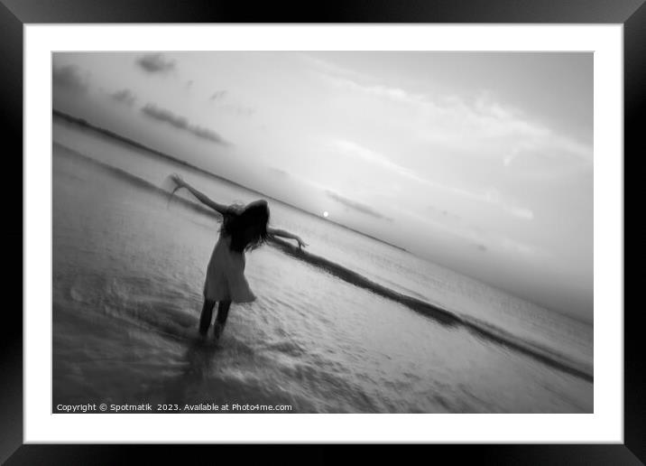 Motion blur girl standing in ocean at sunrise Framed Mounted Print by Spotmatik 