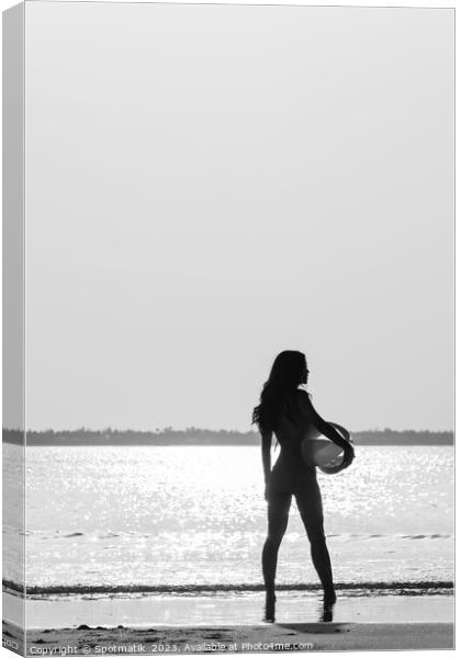 Tropical ocean sunrise with girl holding beach ball Canvas Print by Spotmatik 